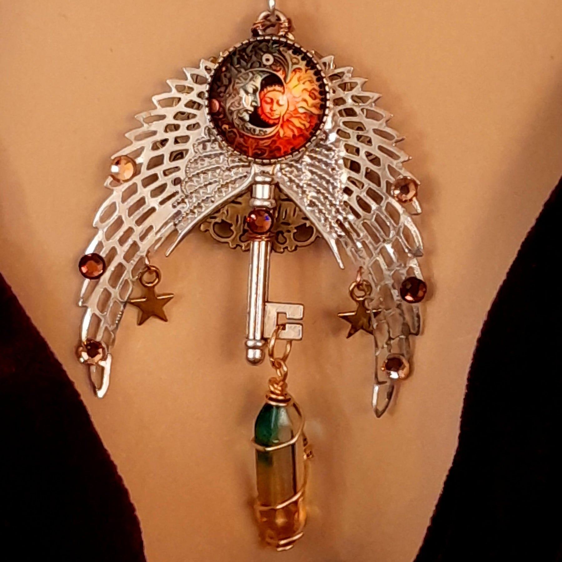 bohemian necklace with sun and moon cabochon, wings, stars, color changing crystal, and swarovski crystals