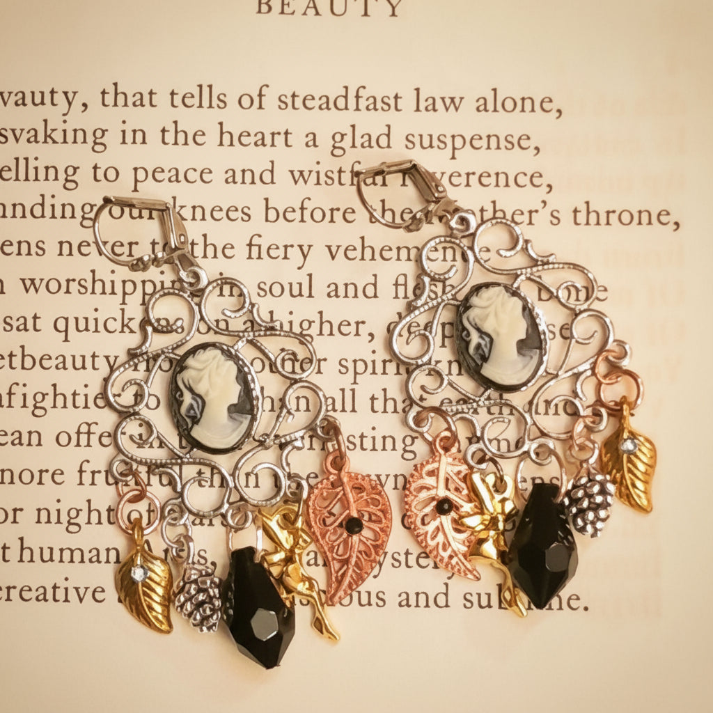 Romantic Victorian style cameo earrings featuring jet black Swarovski crystals, curling scrollwork, leaf charms, pinecones, and chandelier movement, vintage style earrings by Rachel Flam Design