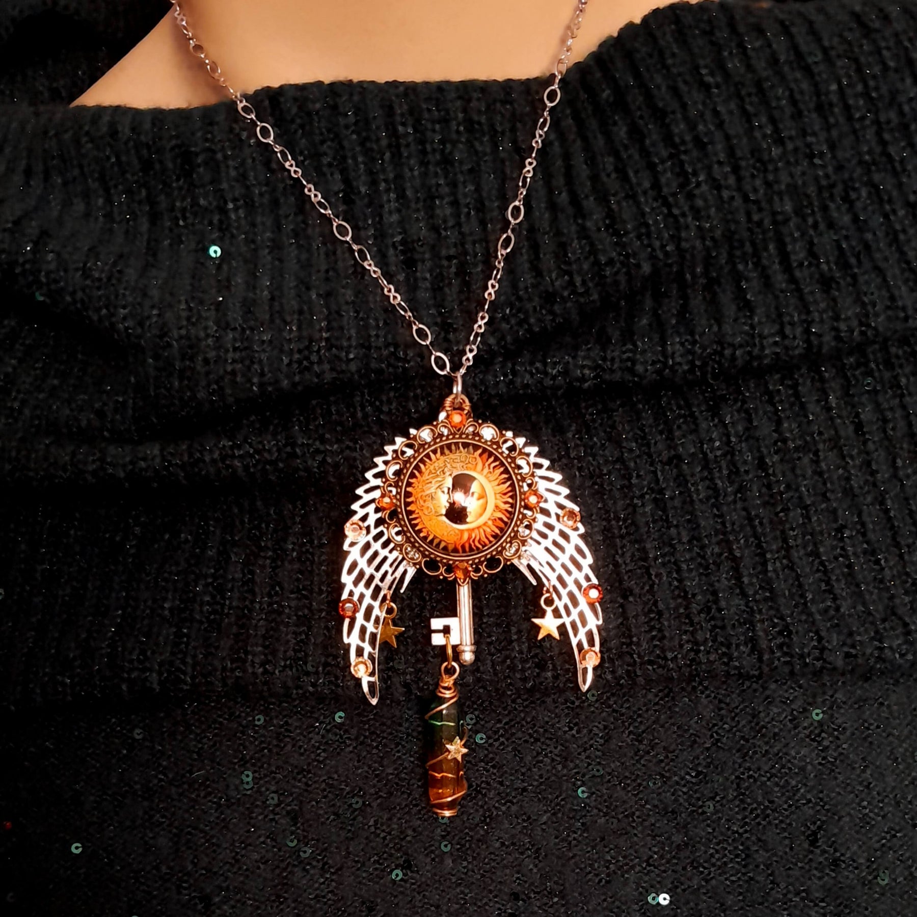 bohemian necklace with sun and moon cabochon, wings, stars, color changing crystal, and swarovski crystals