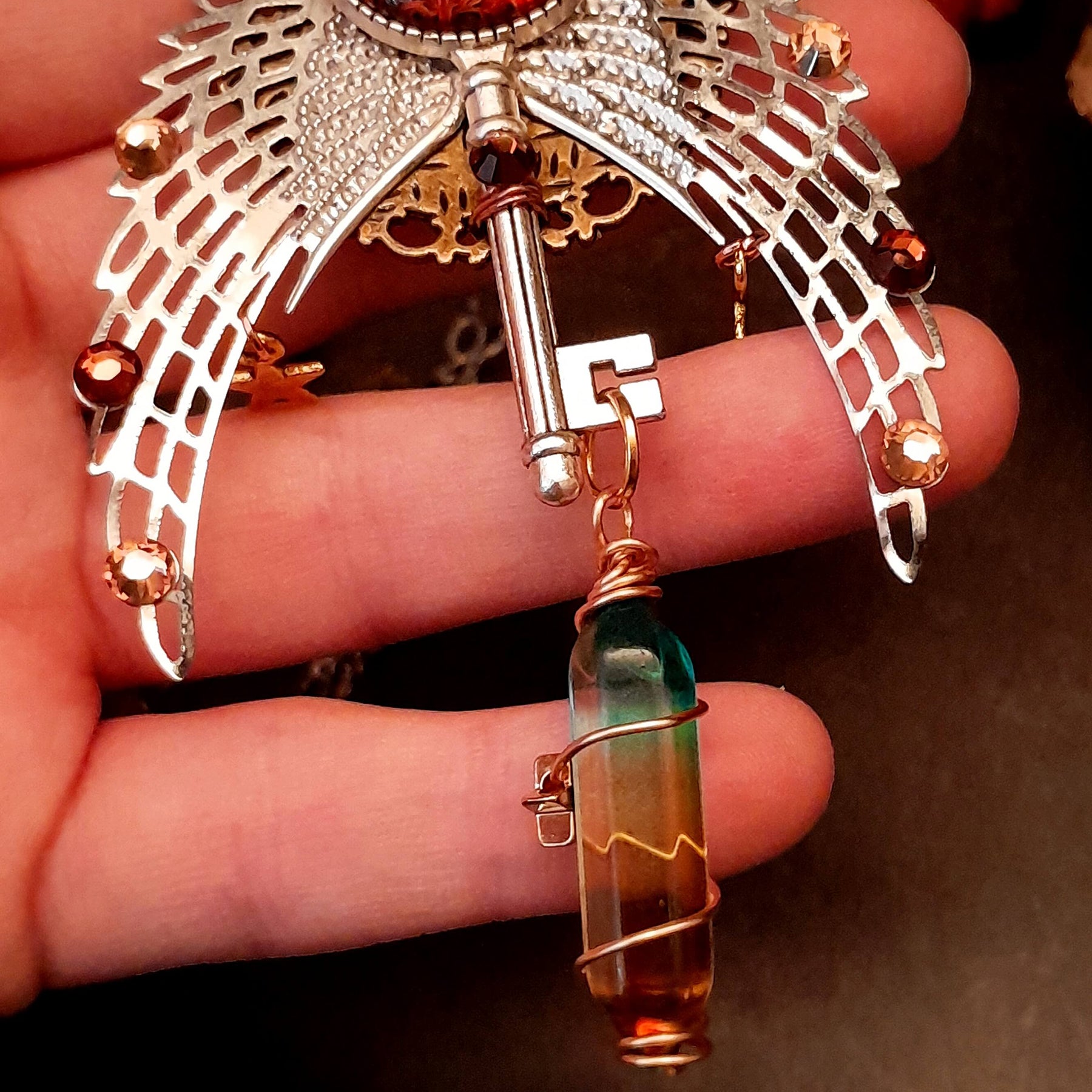 bohemian necklace with sun and moon cabochon, wings, stars, color changing crystal, and swarovski crystals