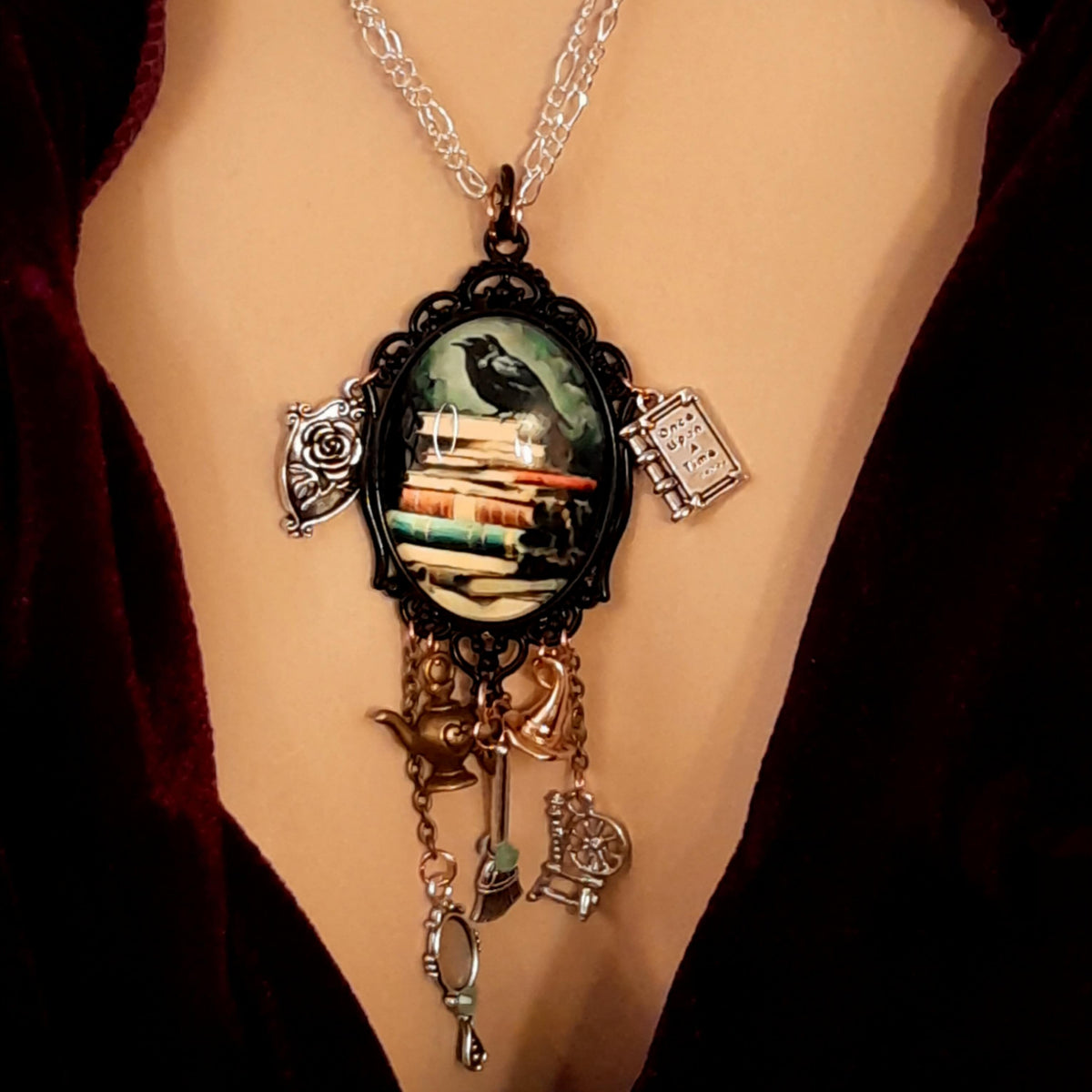 fairytale necklace with book mirror spinning wheel crest magic lamp witch hat broom and crow on books