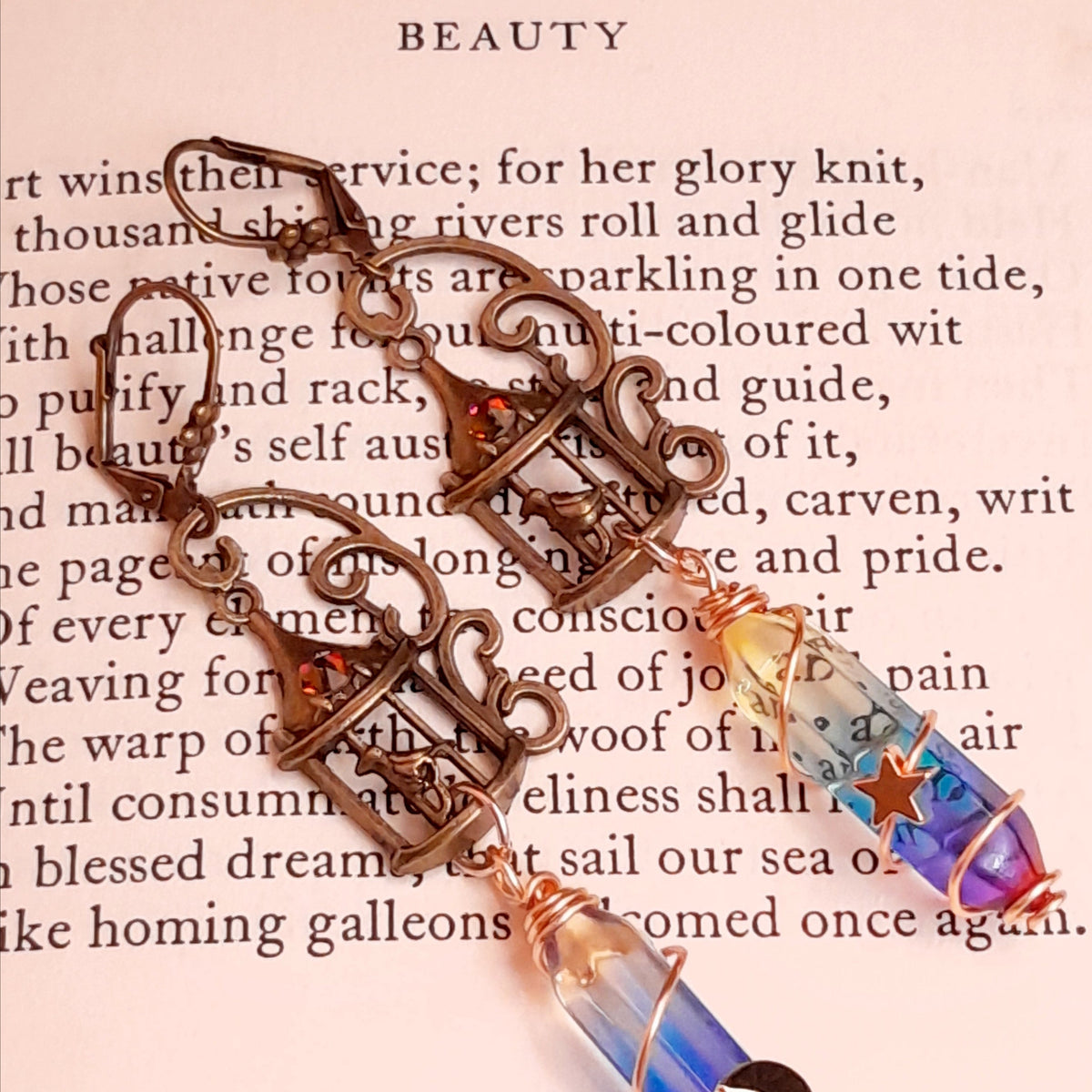 gold moon and star bird cage earrings with blue and purple color changing drop crystals