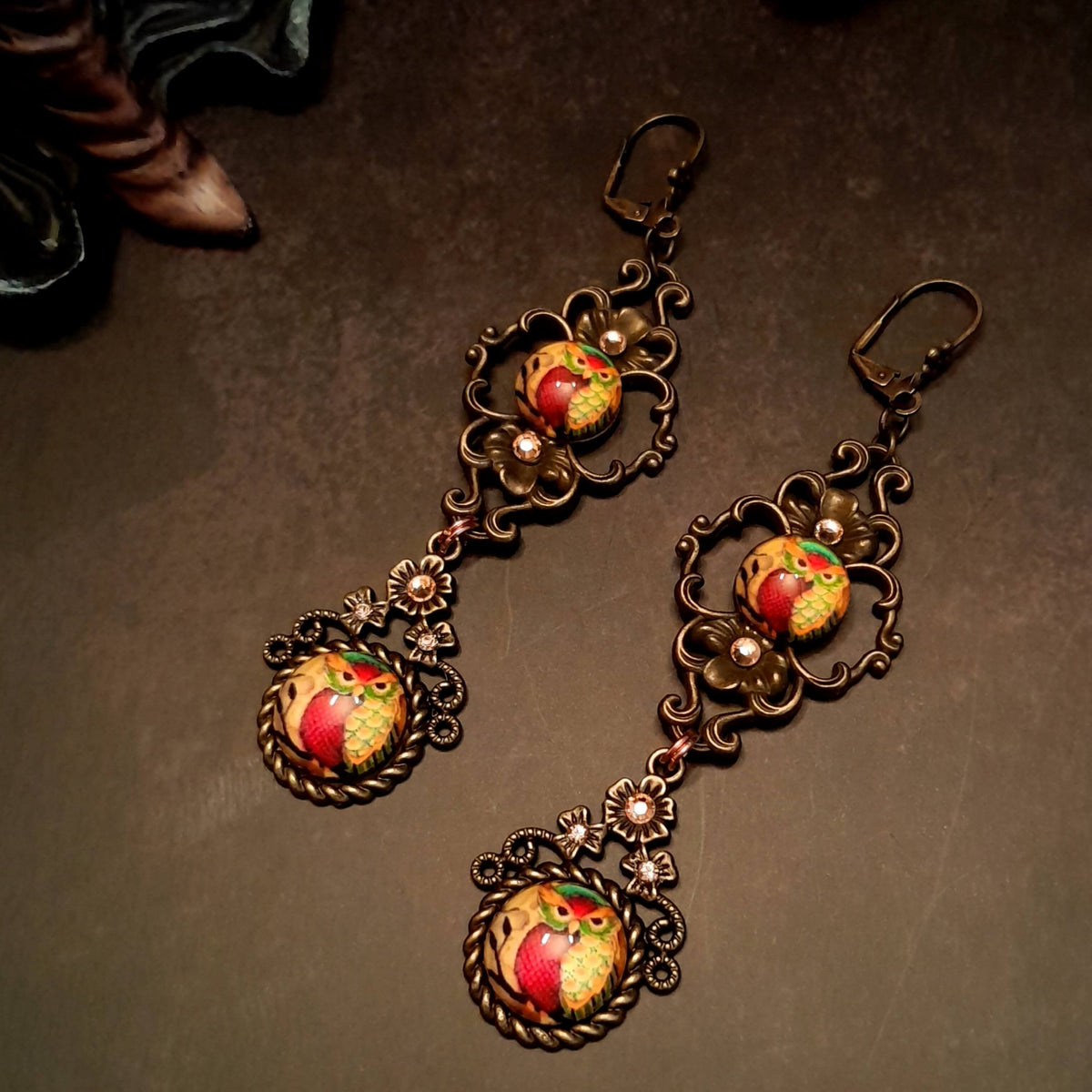 4 owl cabochons nesstled into victorian style brass settings. swarovski crystals