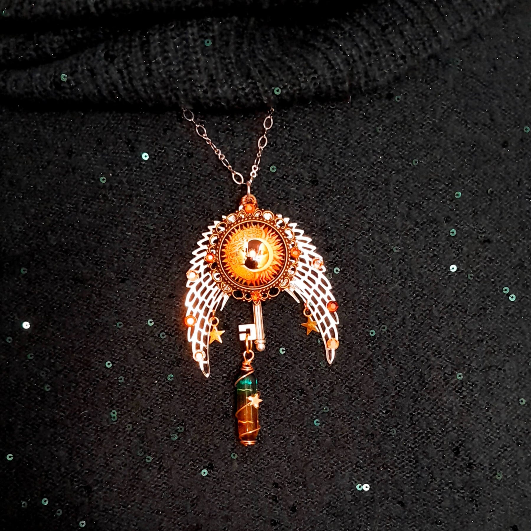 bohemian necklace with sun and moon cabochon, wings, stars, color changing crystal, and swarovski crystals