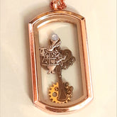 Handmade magical fantasy Alice in Wonderland openable rectangle locket necklace in rose gold tone with White Rabbit charm, gear, clock face, teacup and watch hand charms, Victorian style vintage style