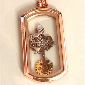 Handmade magical fantasy Alice in Wonderland openable rectangle locket necklace in rose gold tone with White Rabbit charm, gear, clock face, teacup and watch hand charms, Victorian style vintage style