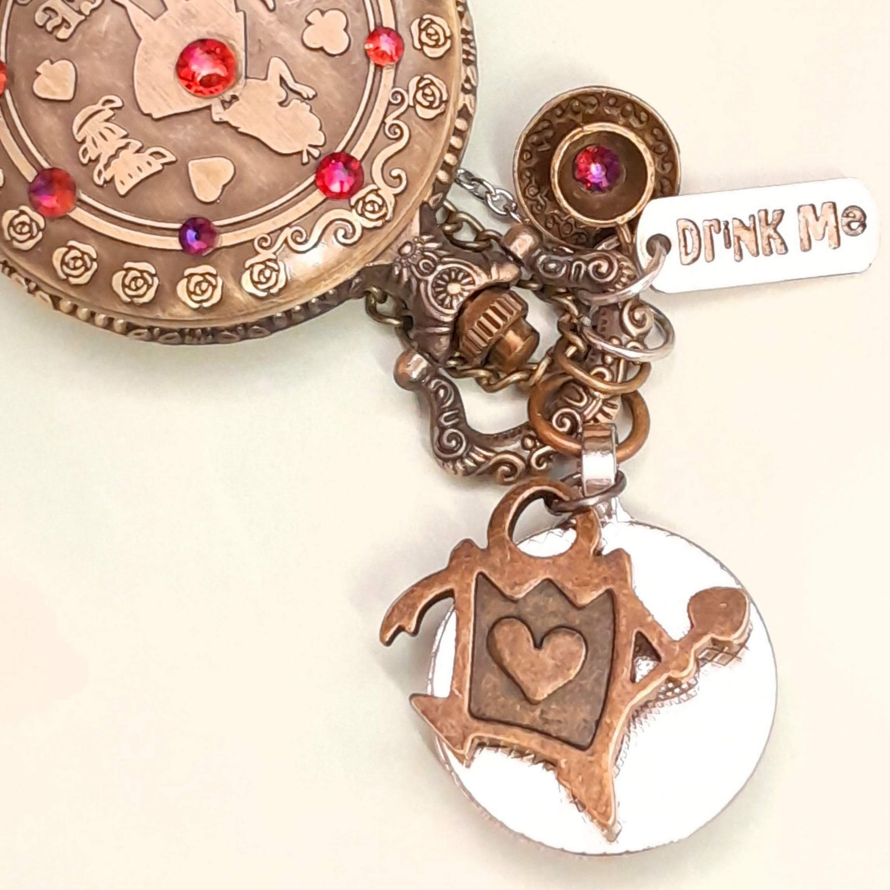 Alice in Wonderland pocket watch necklace back view with Queen of Hearts charm and Drink Me tag red Swarovski crystals antiqued brass Victorian style vintage style fantasy handmade