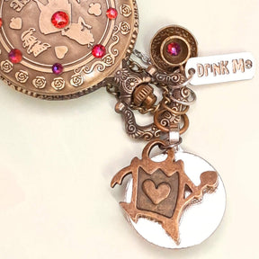 Alice in Wonderland pocket watch necklace back view with Queen of Hearts charm and Drink Me tag red Swarovski crystals antiqued brass Victorian style vintage style fantasy handmade