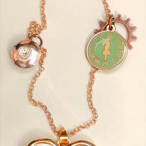 Rachel Flam Design Alice in Wonderland Necklace Heart-Shaped Locket Openable Green Alice Clock Charm Gears Bottom of Teacup with Swarovski Peridot Crystal 