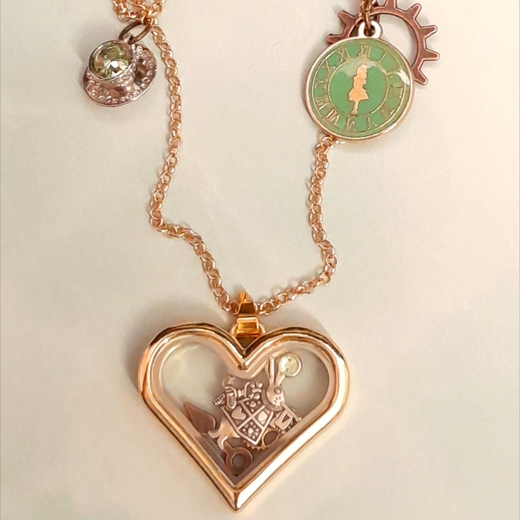 Locket necklace heart shape Alice in Wonderland White Rabbit Clocks Gears Teacup Flatlay 