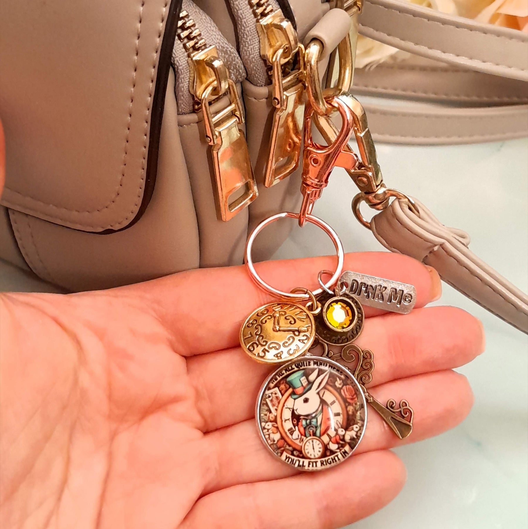 Alice in Wonderland magical fantasy purse charm clipped to zipper pull with White Rabbit clock face, teacup, Drink Me tag, ornate key, and Swarovski crystal — Victorian style vintage style