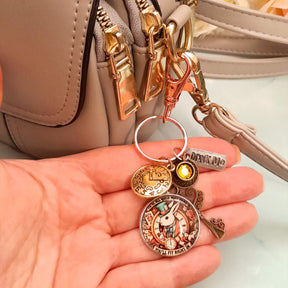Alice in Wonderland magical fantasy purse charm clipped to zipper pull with White Rabbit clock face, teacup, Drink Me tag, ornate key, and Swarovski crystal — Victorian style vintage style