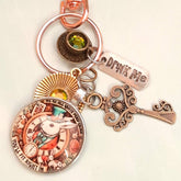 Alice in Wonderland magical fantasy purse charm with White Rabbit clock face, teacup, Drink Me tag, ornate key, and Vitrail Medium Swarovski crystal — Victorian style vintage style
