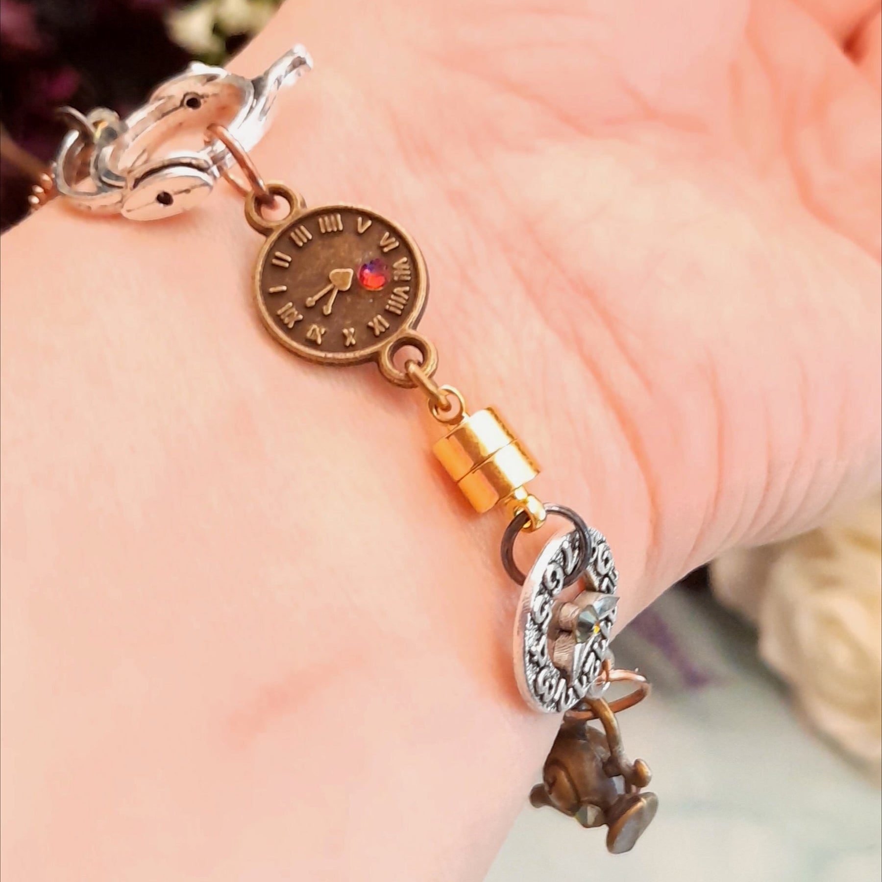 Magical fantasy Alice in Wonderland Victorian style hand chain watch close up of adjustable ring charms showing White Rabbit framed charm and Swarovski crystals magnet clasp