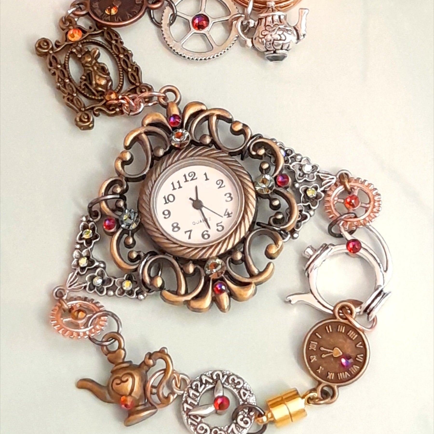 Handmade Alice in Wonderland Victorian style hand chain watch with Swarovski crystals worn on hand showing White Rabbit charm and clock disc