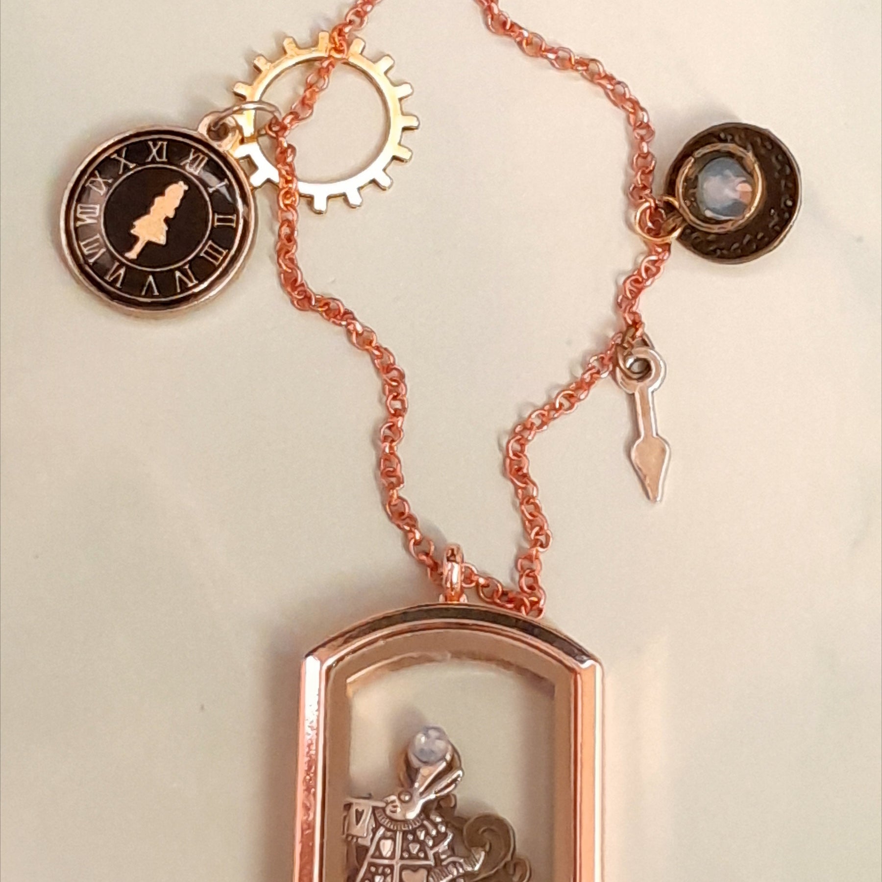 Handmade fantasy Alice in Wonderland openable locket necklace with White Rabbit inside, sun disc charm, gear and watch hand charms, Victorian style vintage style