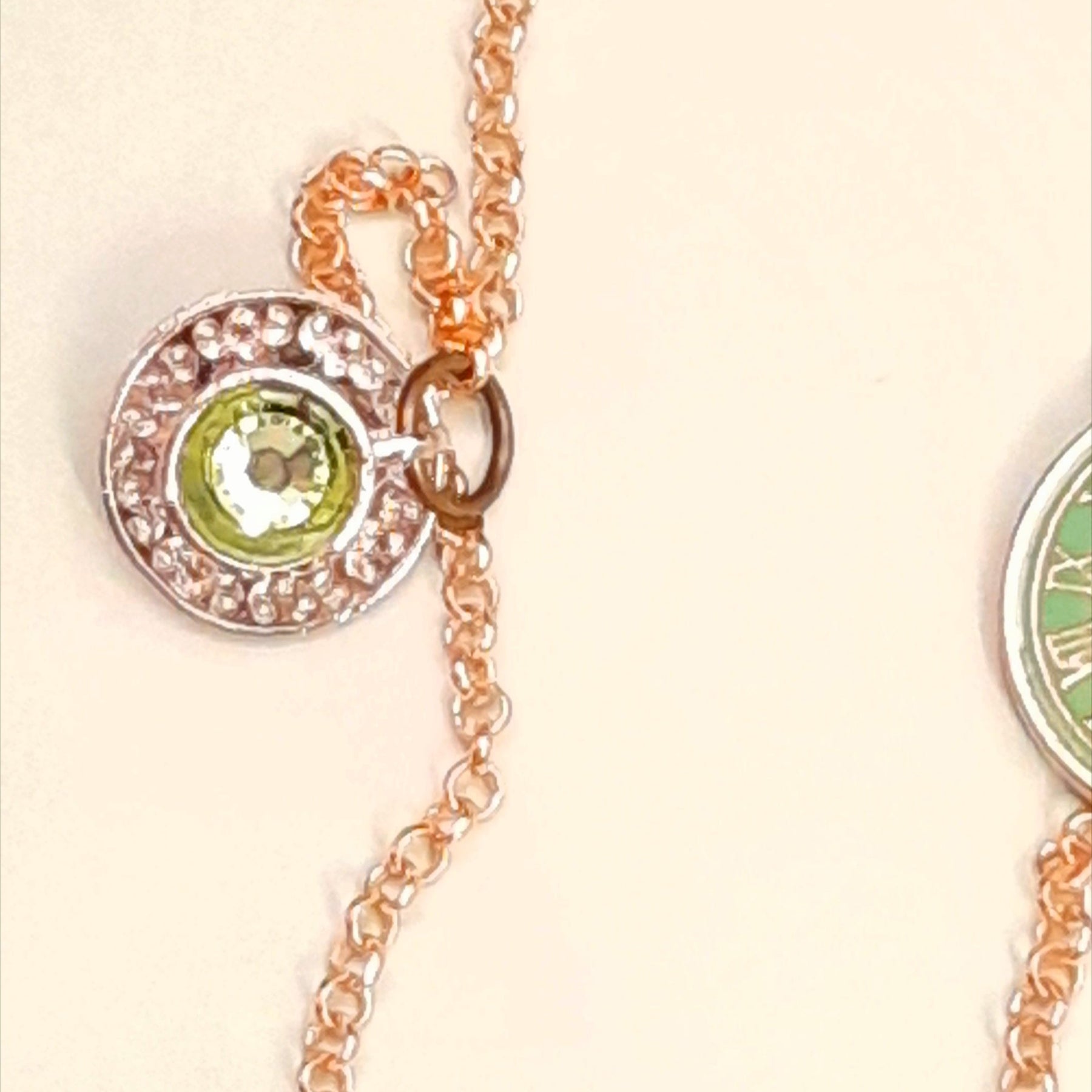 Rachel Flam design Alice in Wonderland locket necklace teacup close up with Swarovski peridot crystal inside the cup 