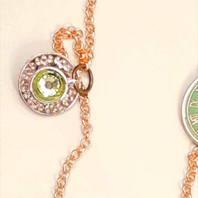 Rachel Flam design Alice in Wonderland locket necklace teacup close up with Swarovski peridot crystal inside the cup 