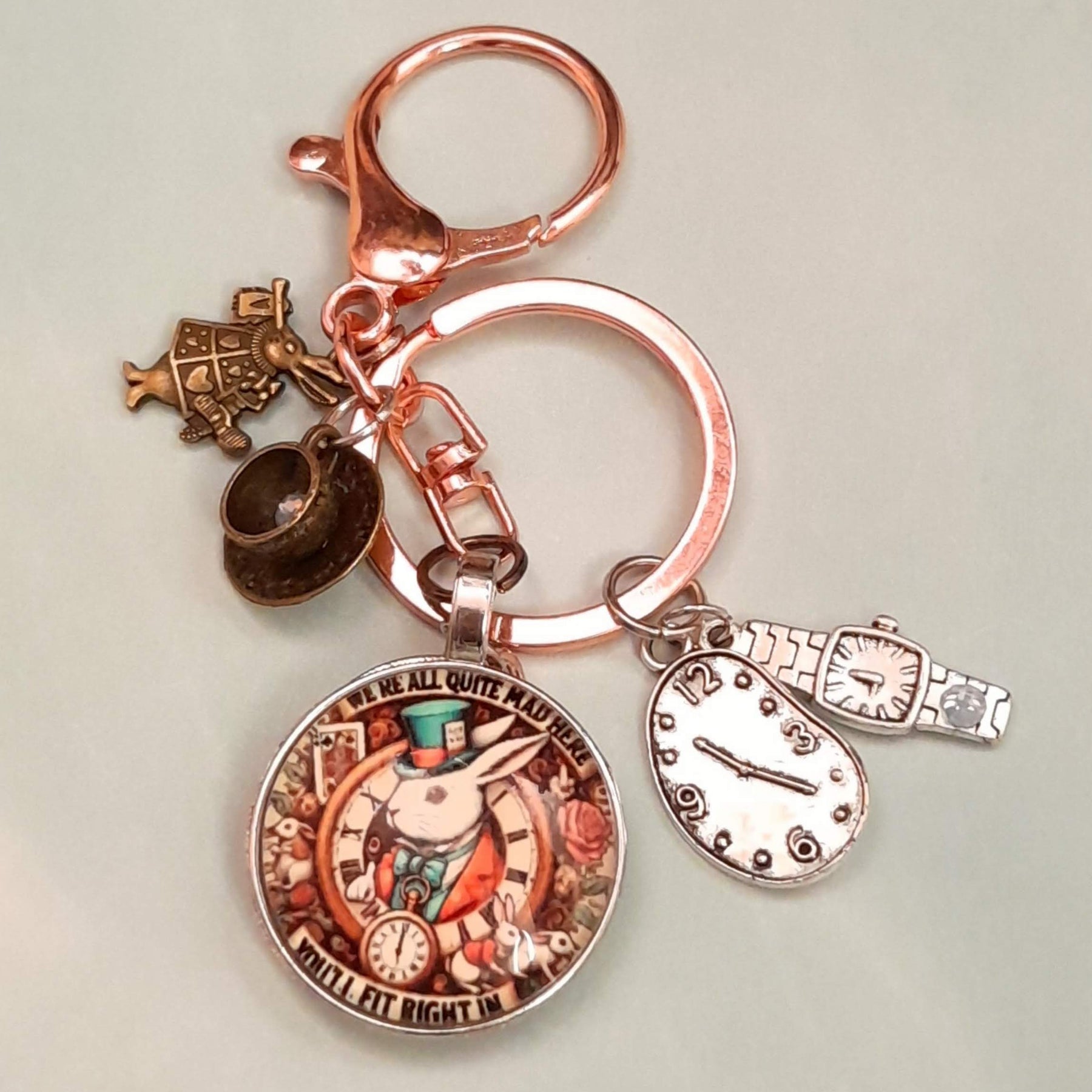 Alice in Wonderland fantasy purse charm and keychain with White Rabbit clock face cabochon, teacup charm with Swarovski crystal, White Rabbit figurine, melting clock, and wristwatch charm — Victorian style vintage style