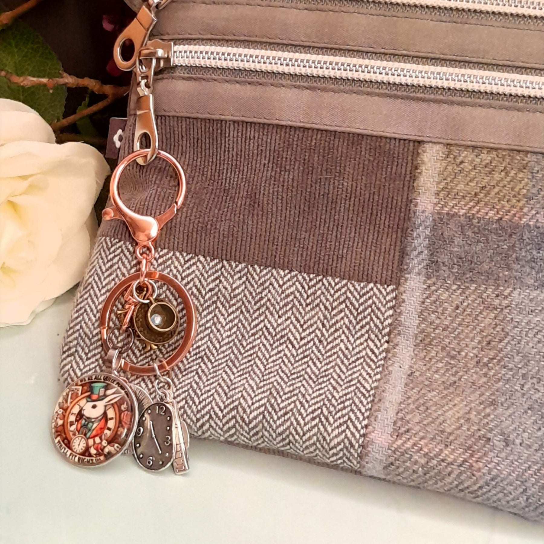 Alice in Wonderland fantasy purse charm and keychain clipped to zipper with White Rabbit clock face cabochon, teacup charm, melting clock teardrop, and White Rabbit figurine — Victorian style vintage style