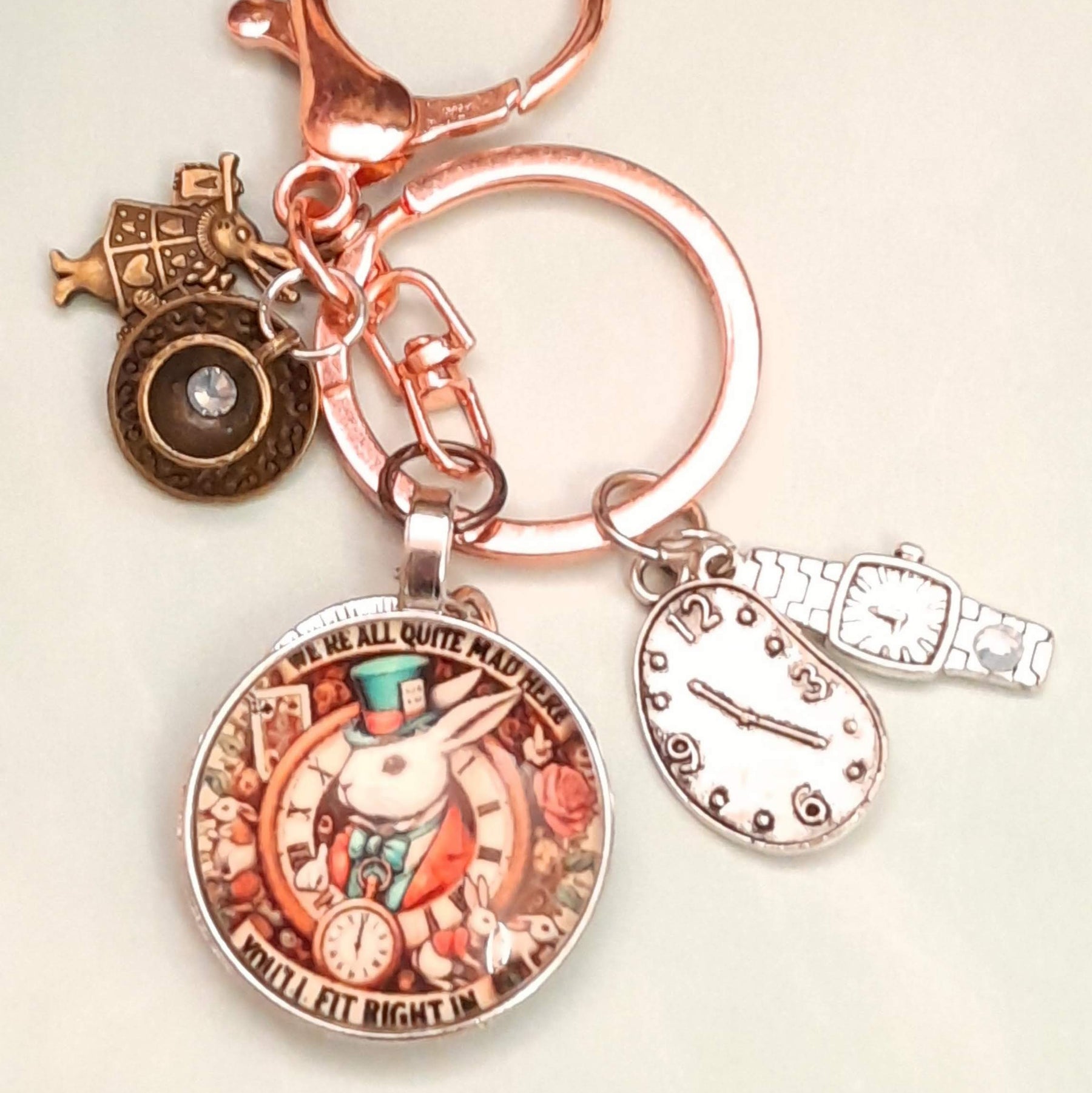 Alice in Wonderland fantasy purse charm and keychain clipped to zipper with round textured disc with Swarovski crystal, melting clock teardrop, wristwatch charm, and White Rabbit figurine — Victorian style vintage style