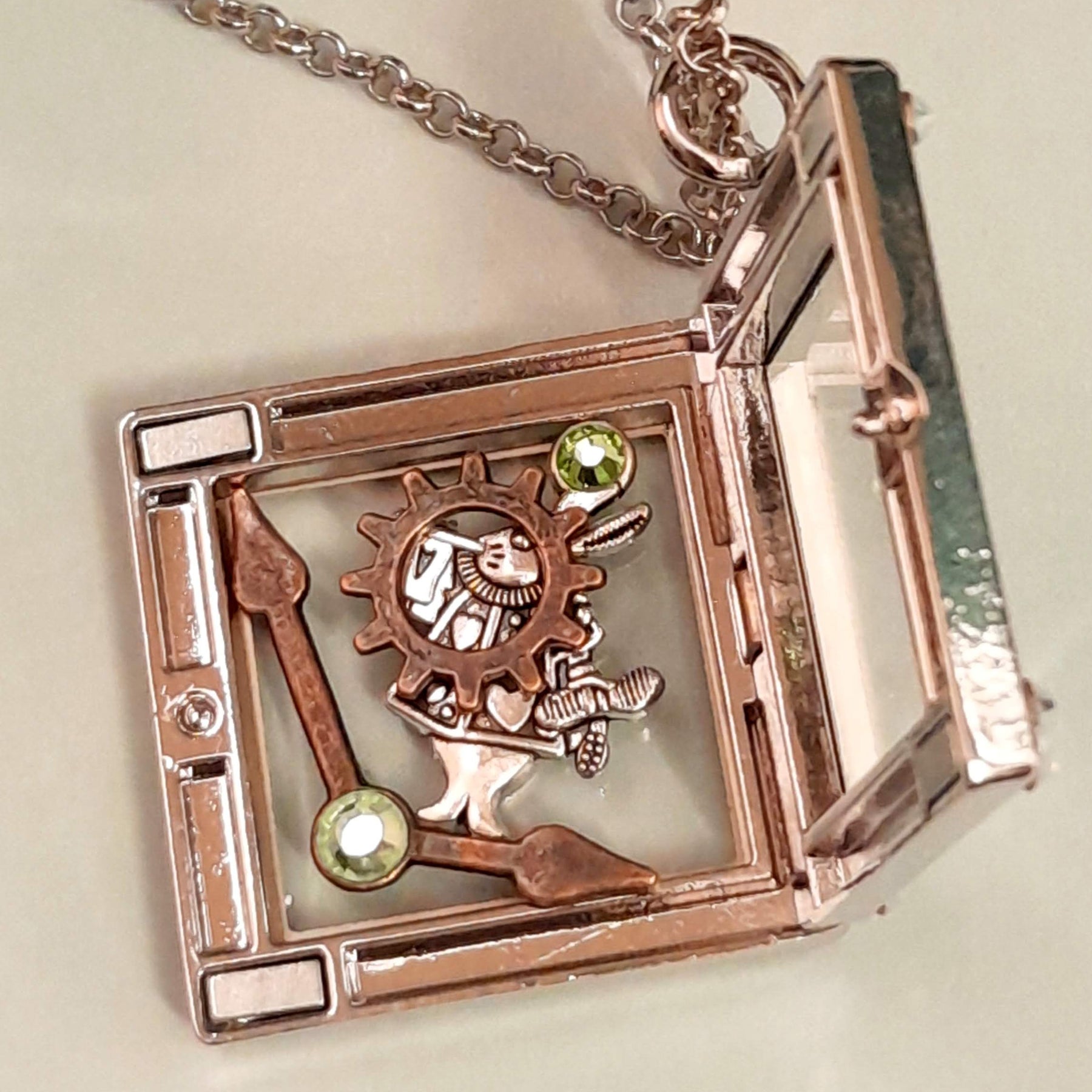Magical fantasy Alice in Wonderland square locket necklace  back view showing crystal corner accents, White Rabbit and gear charms inside,  chain, Victorian style vintage style