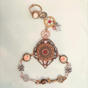Alice in Wonderland steampunk hand chain slave bracelet flat lay showing clock focal point rose cameos keys 3D flowers cameo ring Swarovski crystals Victorian style vintage style handmade Rachel Flam Design