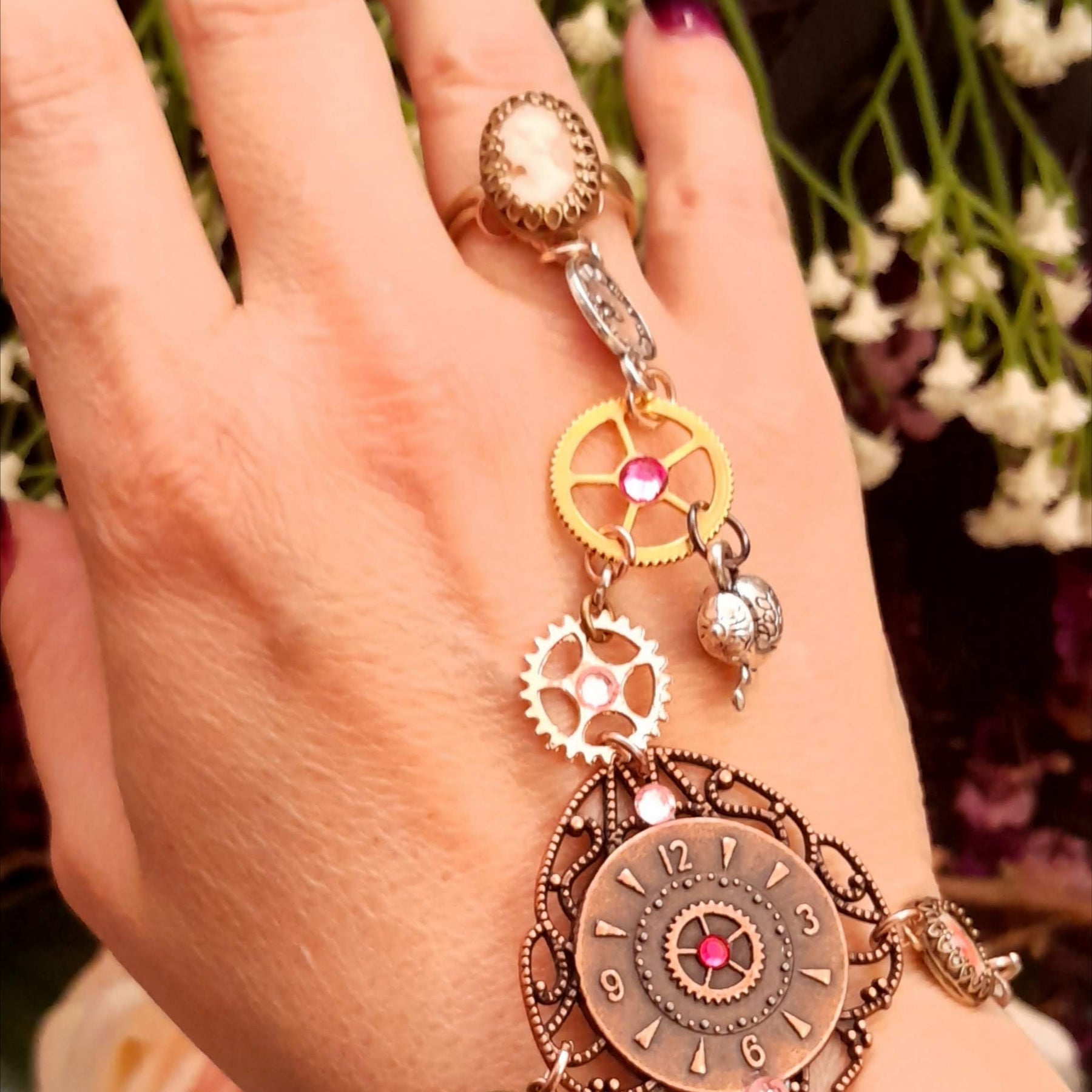 Alice in Wonderland steampunk hand chain slave bracelet side view showing cameo ring steampunk gears clock charm Swarovski rose crystals Victorian style vintage style handmade Rachel Flam Design