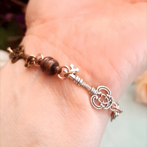Alice in Wonderland steampunk hand chain slave bracelet closeup of ornate key charm wrist band detail Victorian style vintage style handmade Rachel Flam Design