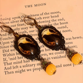 Witchy crow earrings featuring dark birds, autumn woodland imagery, yellow cabochons, rounded pumpkin drops, and sparkling Swarovski crystals, Victorian style and vintage style fantasy jewelry by Rachel Flam Design