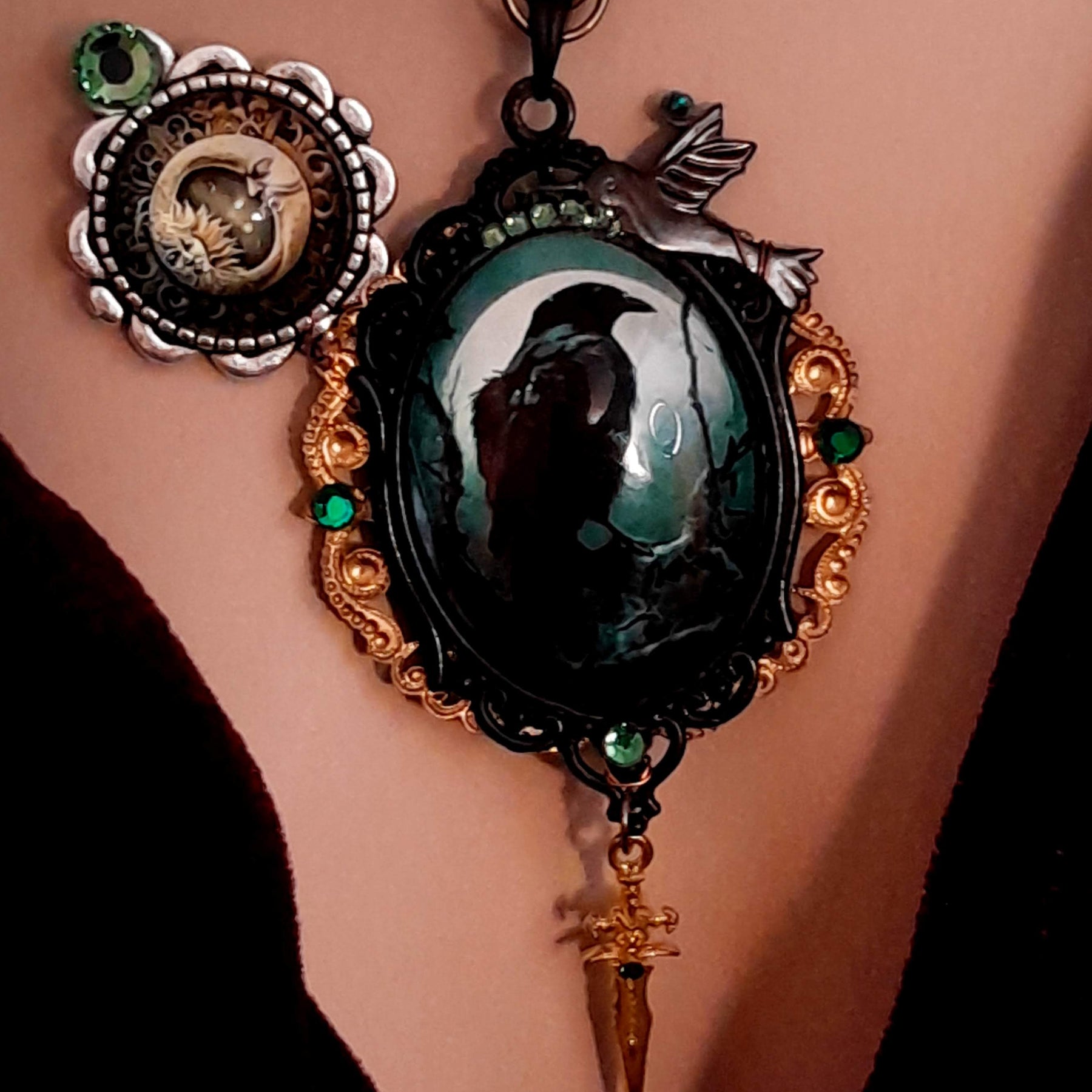 statement necklace with a black raven crow a hummingbird a dagger sun and moon bohemian cabochon on a skeleton key green swarovski crystals