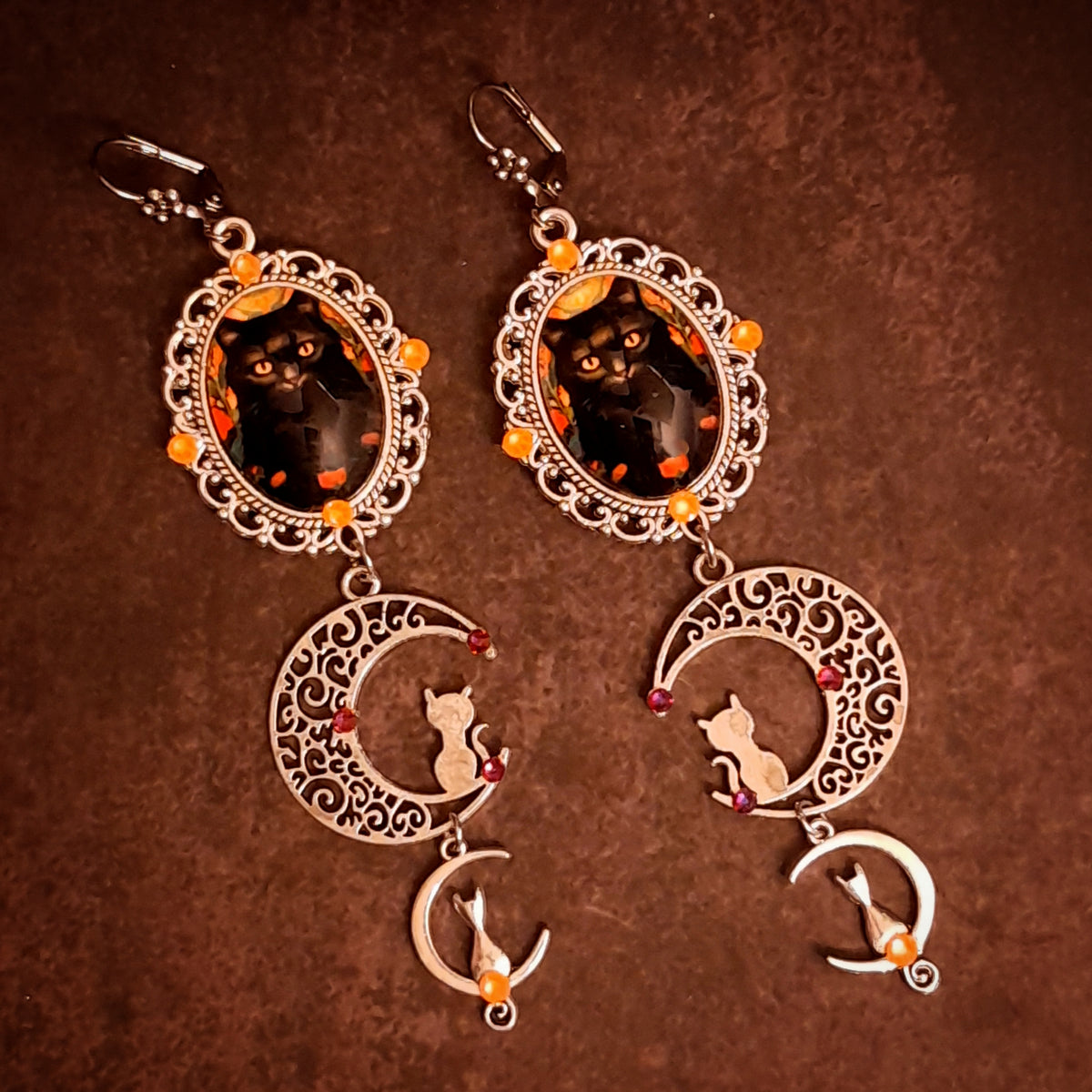 Rachel Flam Design handmade cat and crescent moon dangle earrings with orange Swarovski crystals, Halloween fantasy jewelry in Victorian style and vintage style.