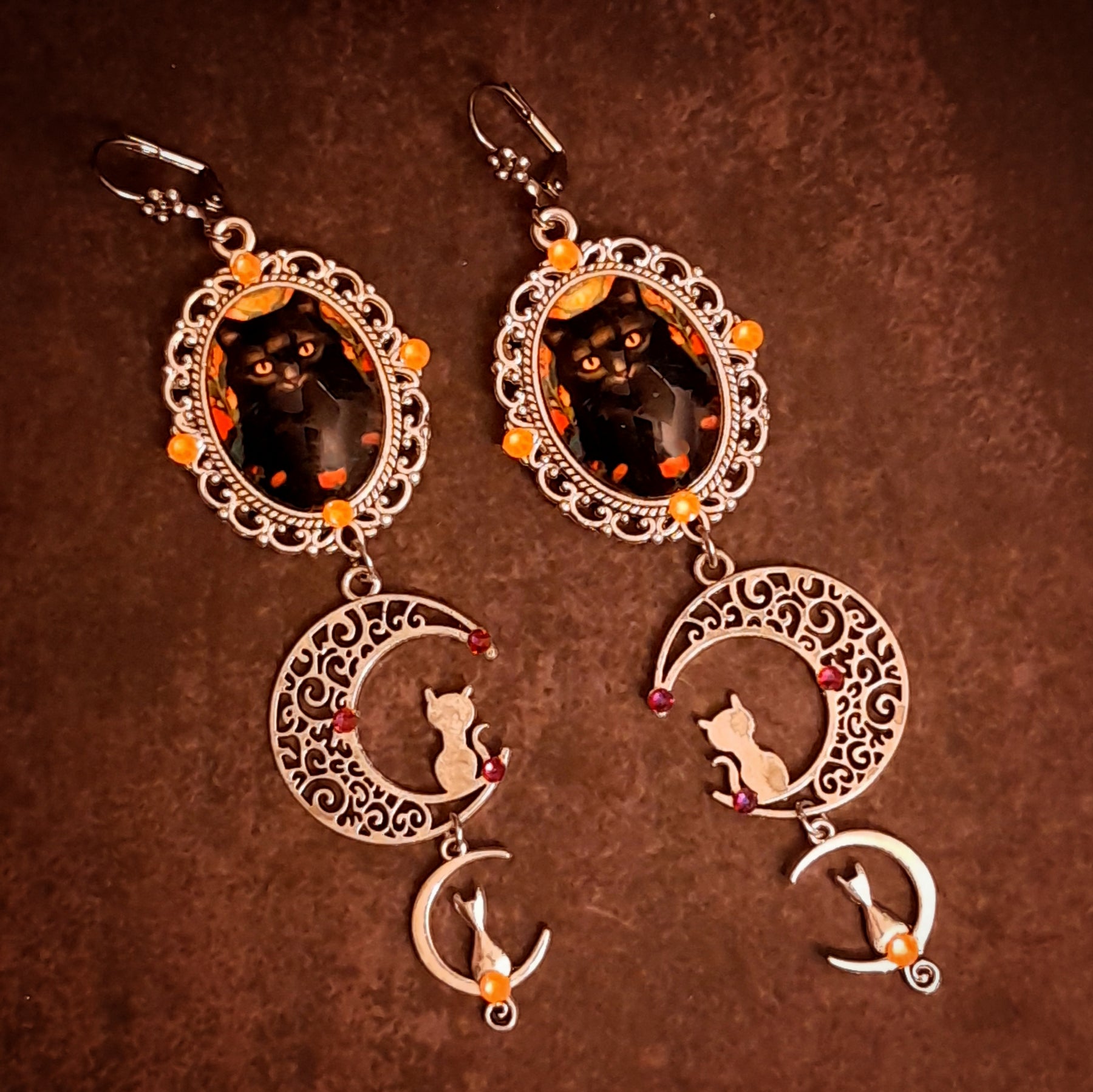 Rachel Flam Design handmade cat and crescent moon dangle earrings with orange Swarovski crystals, Halloween fantasy jewelry in Victorian style and vintage style.