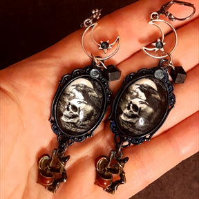 Halloween crescent moon and crow earrings featuring skull imagery, stars, and cauldron-stirring witches, magical dark fantasy Victorian style and vintage style jewelry by Rachel Flam Design