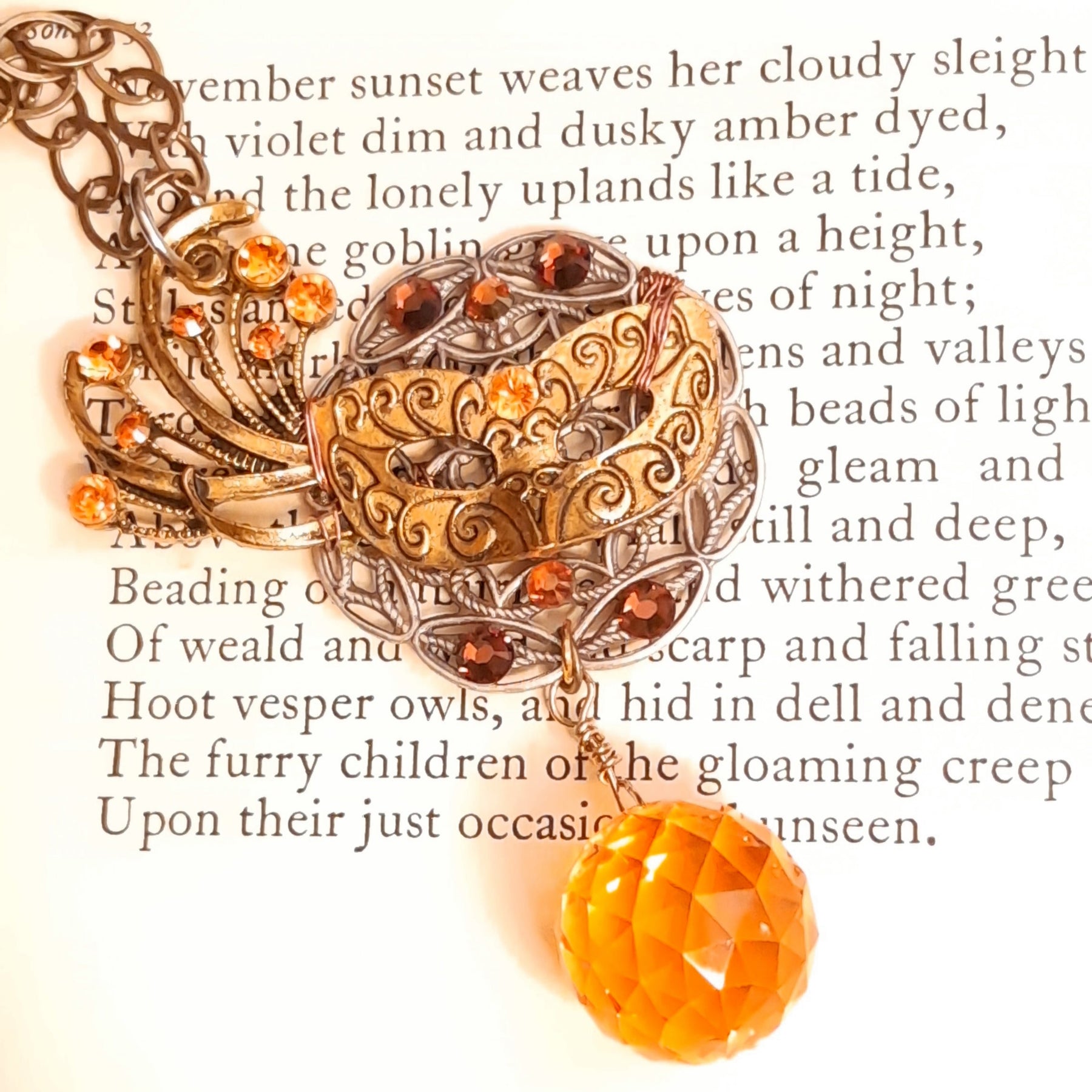 Handmade Masquerade necklace featuring botanical filigree, sparkling orange Swarovski crystals, and a glowing Citrine crystal ball, enchanted autumn harvest Halloween jewelry in Victorian style and vintage style by Rachel Flam Design