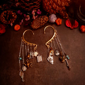 Victorian style vintage style fairy tale ear wrap for non-pierced ears showcasing Once Upon a Time book, pumpkin carriage, crown, oval mirror, family crest, treasure chests, genie lamp, spinning wheel, broom, and cauldron charms with Pacific Opal Swarovski crystals, handmade fantasy jewelry
