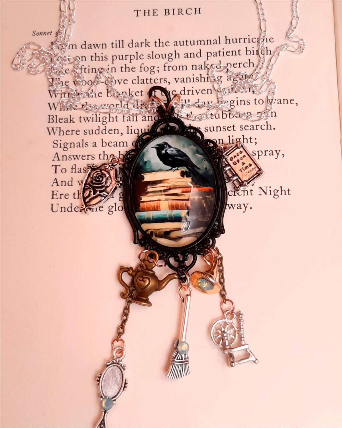 fairytale necklace with book mirror spinning wheel crest magic lamp witch hat broom and crow on books