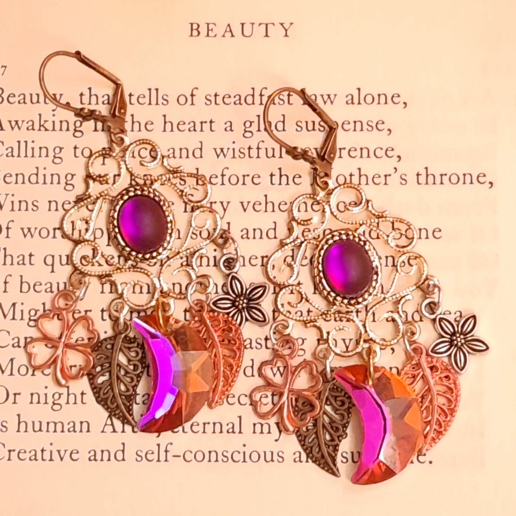Magical fantasy chandelier earrings with fuchsia Swarovski crystals, floral charms, clovers, and dangling leaves in Victorian style and vintage style by Rachel Flam Design