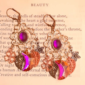Magical fantasy chandelier earrings with fuchsia Swarovski crystals, floral charms, clovers, and dangling leaves in Victorian style and vintage style by Rachel Flam Design
