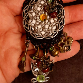 Victorian style vintage style dragon and castle fantasy necklace showing its detailed filigree reverse, magical charms, and Swarovski crystals, Rachel Flam Design