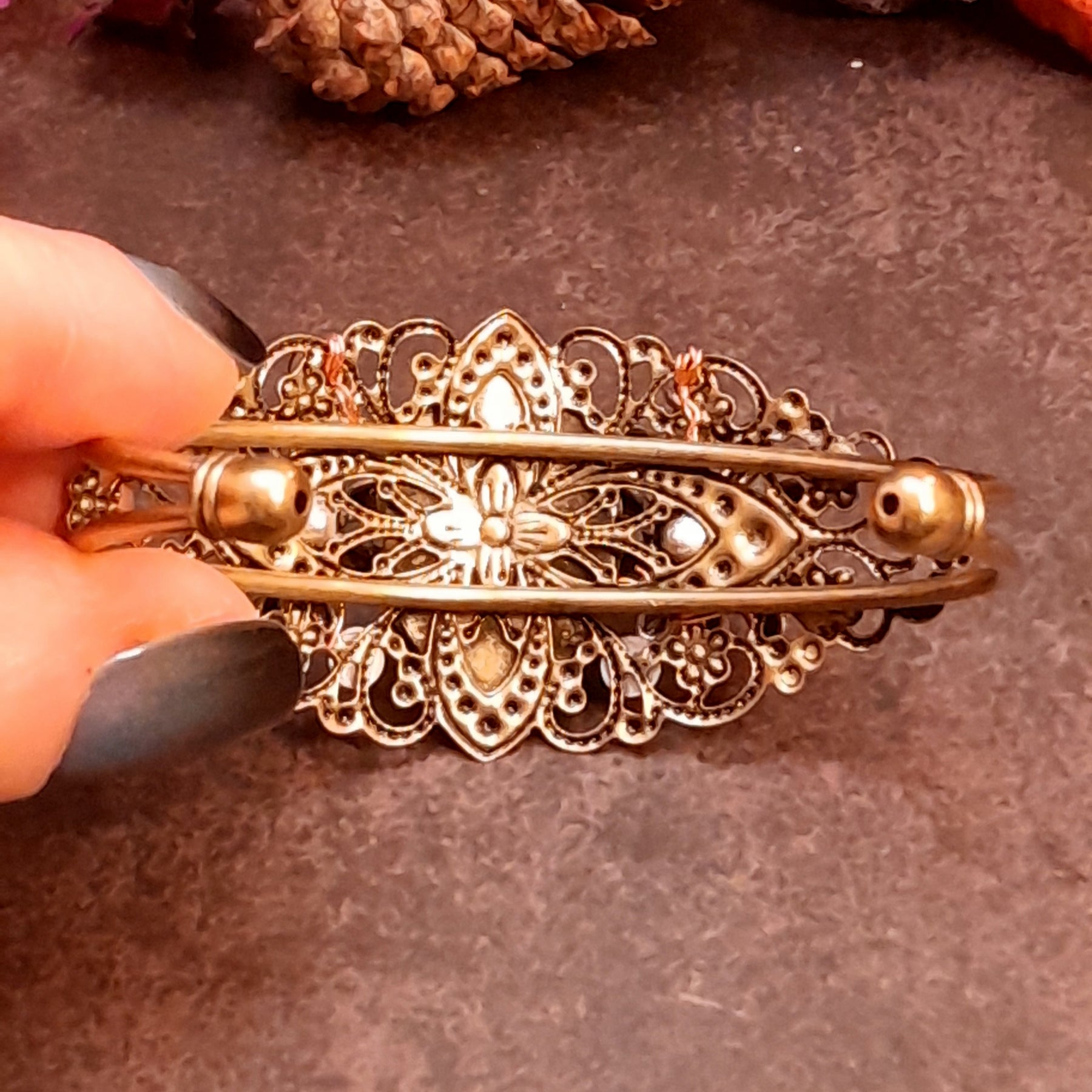 Handmade green cat’s-eye cuff bracelet with curling filigree, flower accents, and bright Swarovski crystals, Victorian style vintage style fantasy jewelry