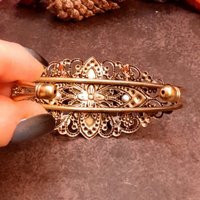 Handmade green cat’s-eye cuff bracelet with curling filigree, flower accents, and bright Swarovski crystals, Victorian style vintage style fantasy jewelry