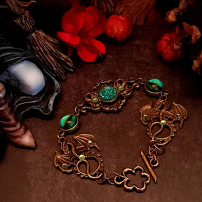 green druzy crystal bracelet with green dragon eyes and brass dragons swarovski green crystals and flower clasp