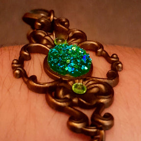 green druzy crystal bracelet with green dragon eyes and brass dragons swarovski green crystals and flower clasp