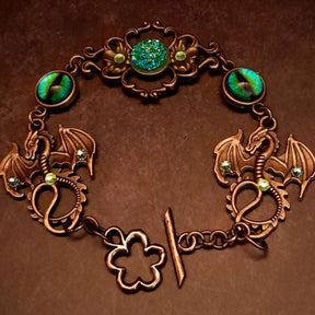 green druzy crystal bracelet with green dragon eyes and brass dragons swarovski green crystals and flower clasp