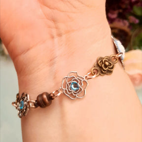 Handmade fantasy bee hand chain slave bracelet  on wrist dramatic close up of bee centerpiece on filigree backing with blue Swarovski crystals and blue floral cameo Victorian style vintage style