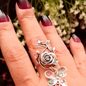 Handmade fantasy owl hand chain on hand close up of adjustable rose ring with butterfly charm and pink Swarovski crystals Victorian style vintage style