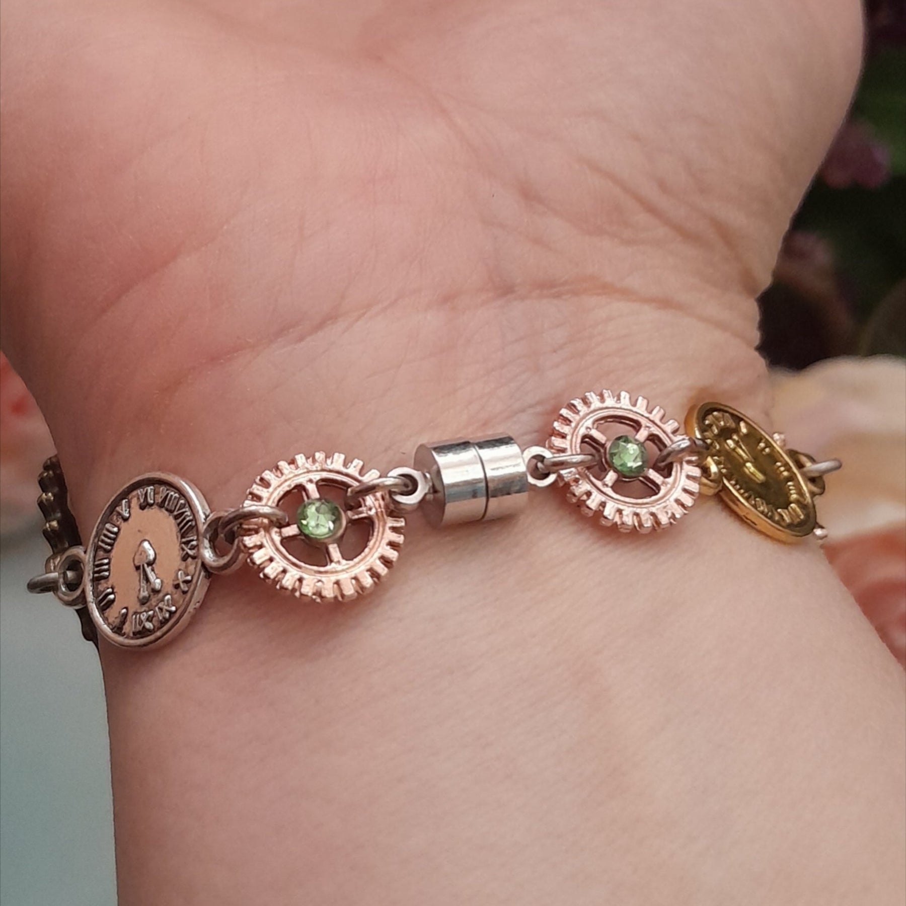 Magical fantasy hand chain teapot watch Alice in Wonderland back view with green Swarovski crystals and steampunk gears, Victorian style vintage style