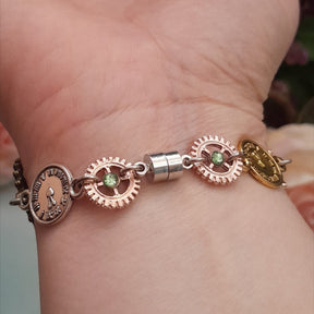 Magical fantasy hand chain teapot watch Alice in Wonderland back view with green Swarovski crystals and steampunk gears, Victorian style vintage style