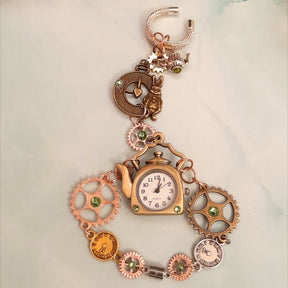 Magical fantasy hand chain teapot watch Alice in Wonderland with green Swarovski crystals flat lay front view, Victorian style vintage style